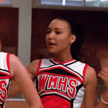 a cheerleader wearing a red and white wmhs jersey