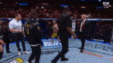 a man in a black shirt with the number 2 on it stands in a boxing ring