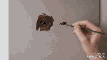 a person is painting a face with a brush and the words made in animatica are visible