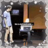 a man standing next to another man with the words " this is what jared wrote " on the screen