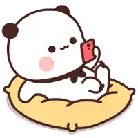 a panda bear is laying on a pillow holding a red cell phone .