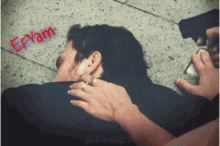 a man laying on the ground with the word efyan written on the bottom