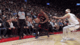 a basketball player wearing number 9 dribbles the ball
