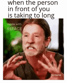 a man with a beard is making a funny face with his hands in front of his face .