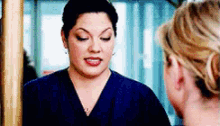 two women are looking at each other in the mirror .