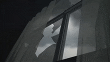 a broken window with a cloudy sky visible