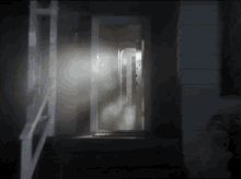 a door with smoke coming out of it and stairs leading up to it