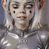 a close up of a woman 's face with the word voo written on her chest