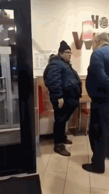 a burger king sign is on the wall behind a man