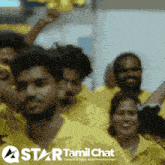a group of people wearing yellow shirts with a star tamil chat logo on the bottom