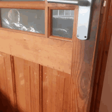 a close up of a wooden door with a window