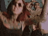 a blurred image of a woman with a tattoo on her arm