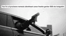a man is sitting in a car holding a gun out the window .