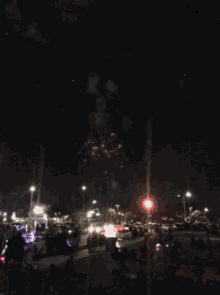 a large firework display is being watched by a crowd