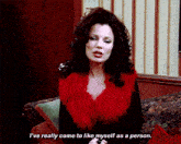 a woman is sitting on a couch and says " i 've really come to like myself as a person "