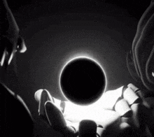 a black and white photo of a person holding a ball in their hand
