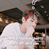 a man sitting at a table with a question mark above his head and the words " anong pinagsasabi mo back off akin yan "