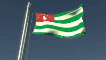a green white and red flag with a white hand in the middle