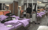 a bedroom with purple sheets and a black pillow that says " show "