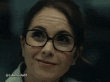 a close up of a woman wearing glasses with the hashtag liaalmeida05