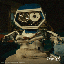 a robot is standing next to a pile of clothes and says fantastic 4 first steps