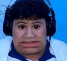 a man wearing headphones makes a funny face with his mouth open