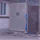 two women wrapped in blue blankets are walking in front of a door
