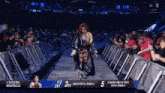 a female wrestler is walking down the aisle at a royal rumble