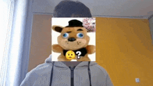 a stuffed teddy bear with a question mark on its face