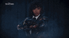 a woman named tiffany mitchell big brother stands in front of a curtain