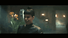 a woman with a bun in her hair is smiling