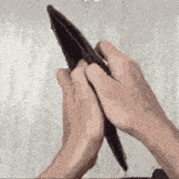 a person is holding an empty wallet with their hands