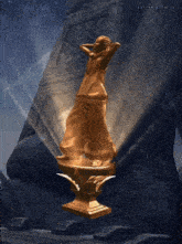 a statue of a woman standing on a pedestal with the word play written on the bottom right