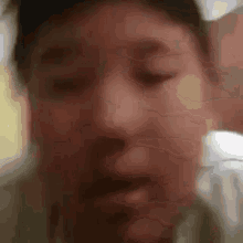 a close up of a person 's face with a blurred background