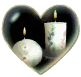 two candles inside of a heart shaped frame