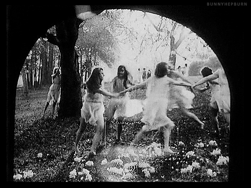 Women dancing in a girl in a field / forest, maybe under a full Moon.