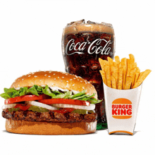 a coca cola glass next to a hamburger and french fries from burger king