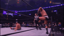 a man is standing in a wrestling ring with a rope around his waist .