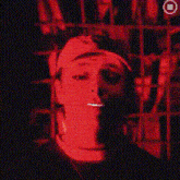 a close up of a person 's face in red light .