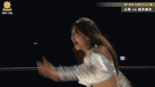 a woman in a white dress is dancing in front of a sign that says miyama