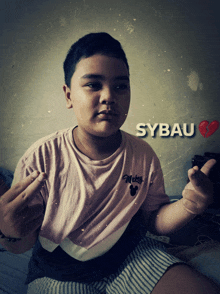 a young boy wearing a mickey mouse shirt with sybau written on the bottom