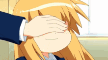 a person covering a girl 's eye with their hand