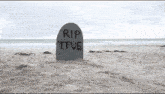 a gravestone on a beach that says rip tfue on it