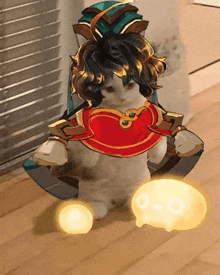 a cat is standing on a wooden floor wearing a costume and holding a skull .