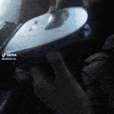 a close up of a person 's hand holding a device that says tiktok