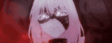a girl with white hair and a mask on her face is looking at the camera .