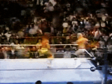a blurry picture of a wrestling match with a crowd watching