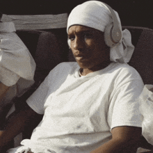 a woman wearing headphones and a white headband