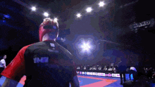 a man in a boxing ring with the word jako on the wall behind him