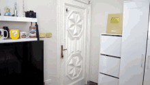 a room with a door and a shelf with a mug that says " you tube "